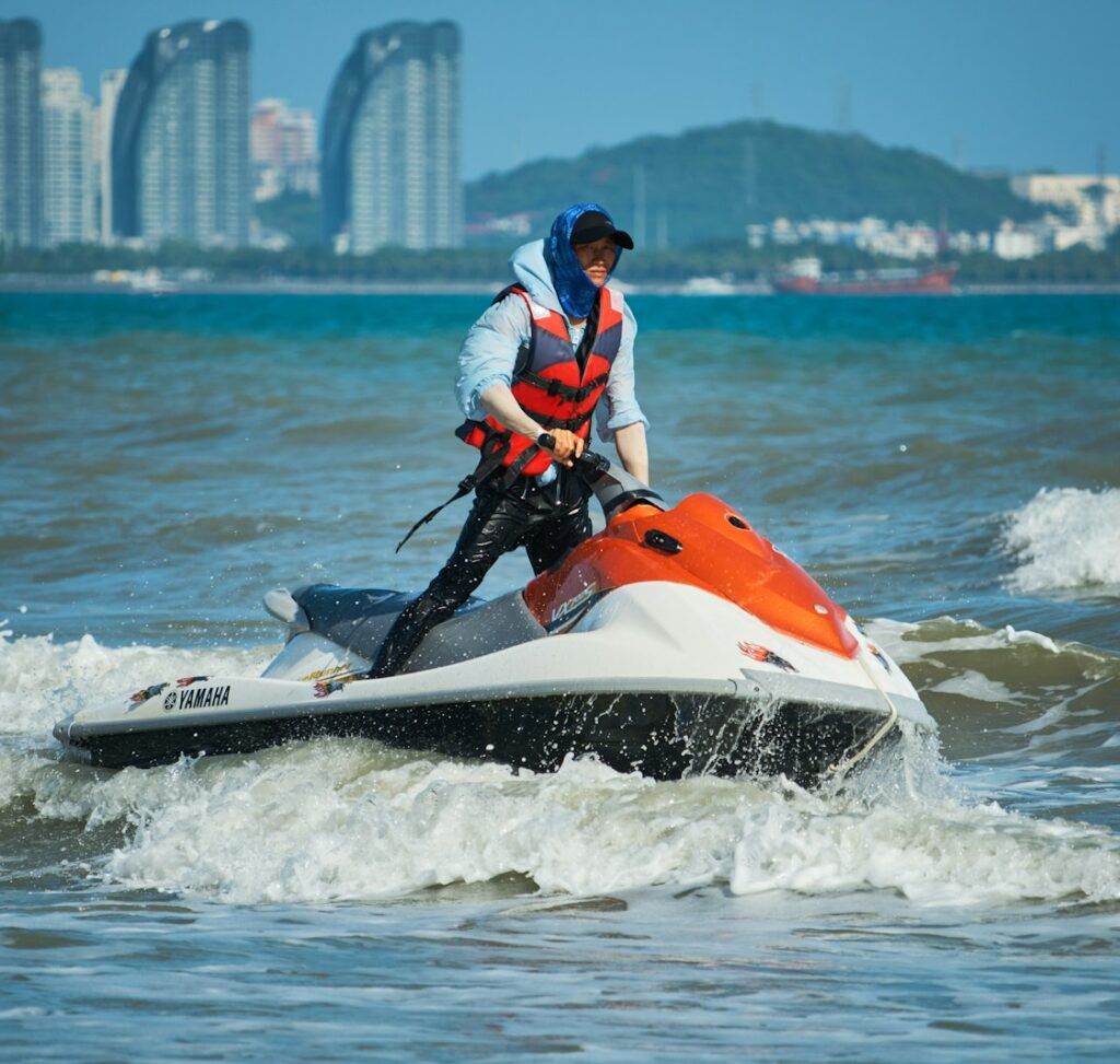 a man riding a jet ski on top of a body of water